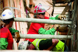 Construction laborers work on an office building in Boston