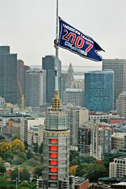 weather beacon fitted with a red sox championship banner sits atop the John Hancock building in Boston's Copley Square